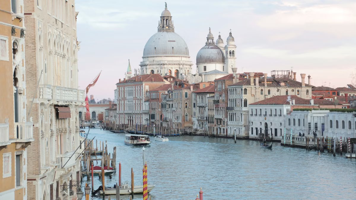 View of grand canal and old cathedral of Santa Maria della Salute in Venice in Italy on early calm morning